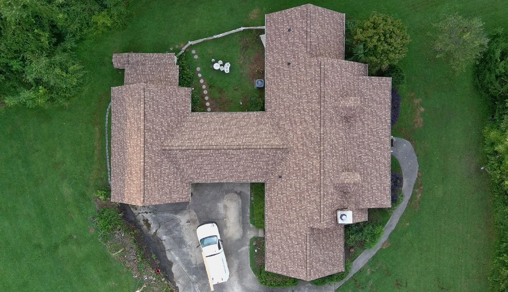 Top-down drone view of the same home after Iron Ridge installed a new architectural shingle roof